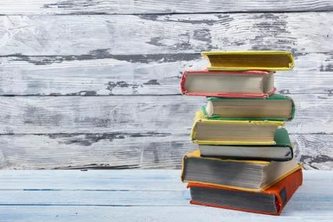 Stack of hardback books on wooden table. Back to school. Copy space for text Stock Photos