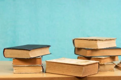 Stack of hardback books on wooden table. Back to school Stock Photos