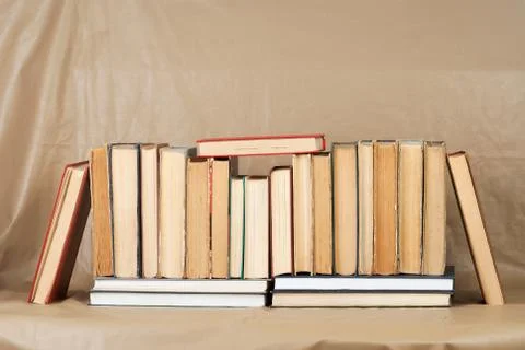Stack of hardback books on wooden table Stock Photos