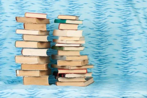 Stack of hardback books on wooden table Stock Photos