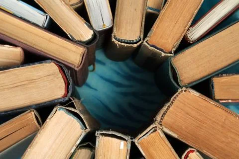 Stack of hardback books on wooden table Stock Photos
