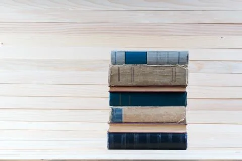 Stack of hardback books on wooden table. Back to school. Stock Photos