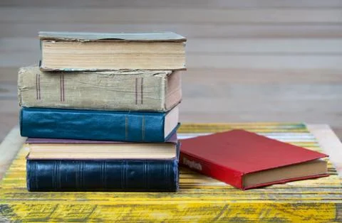 Stack of hardback books on wooden table. English textbook. Stock Photos