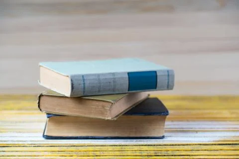 Stack of hardback books on wooden table. Back to school. Stock Photos