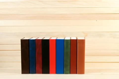 Stack of hardback books on wooden table Stock Photos