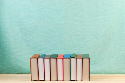 Stack of hardback books on wooden table Stock Photos