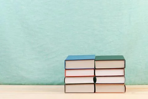 Stack of hardback books on wooden table Foto stock