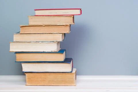 Stack of hardback books on wooden table. Back to school Stock Photos
