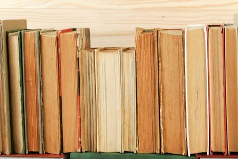 Stack of hardback books on wooden table Stock Photos
