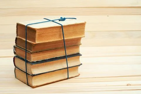 Stack of hardback books on wooden table. Back to school. Stock Photos