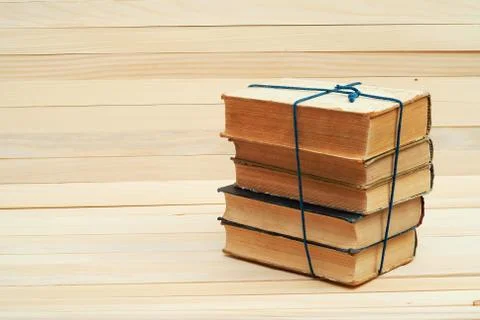 Stack of hardback books on wooden table. Back to school. Stock Photos
