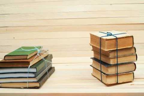 Stack of hardback books on wooden table. Back to school. Stock Photos
