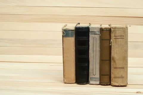 Stack of hardback books on wooden table Stock Photos