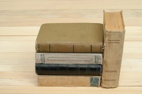 Stack of hardback books on wooden table Stock Photos