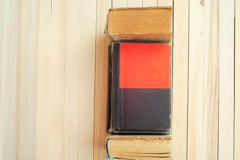 Stack of hardback books on wooden table Stock Photos