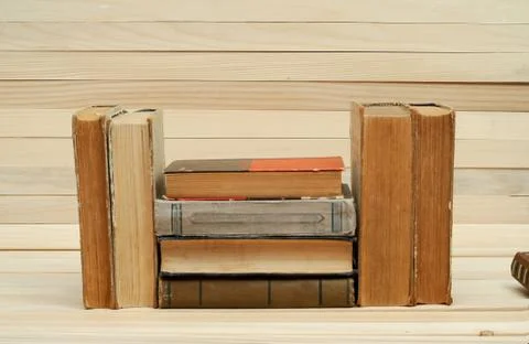 Stack of hardback books on wooden table Stock Photos