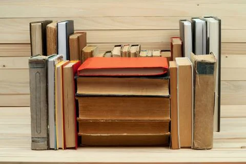 Stack of hardback books on wooden table Stock Photos