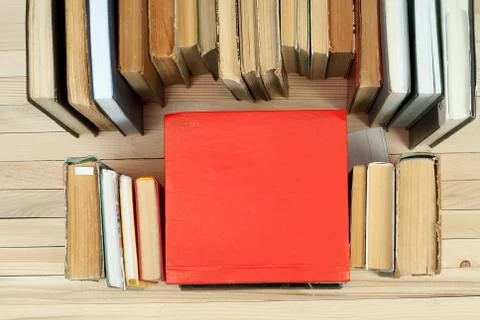 Stack of hardback books on wooden table Stock Photos