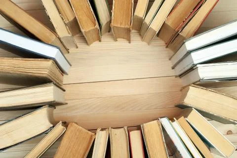 Stack of hardback books on wooden table Stock Photos