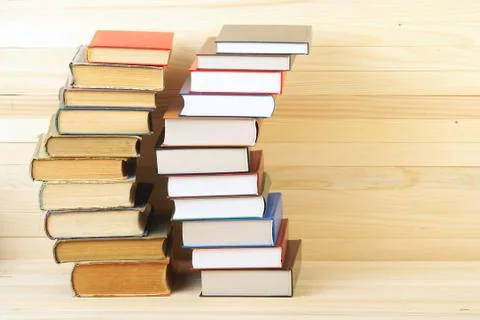 Stack of hardback books on wooden table Stock Photos