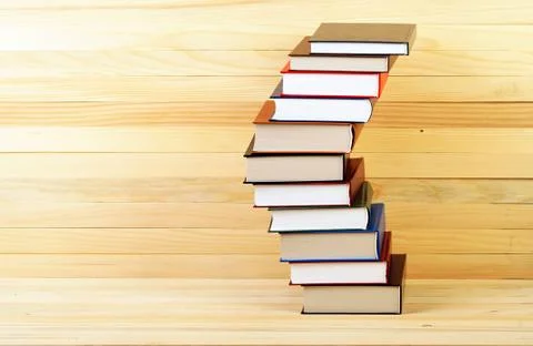 Stack of hardback books on wooden table Foto stock