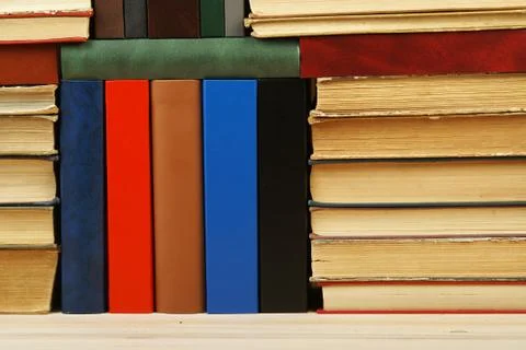 Stack of hardback books on wooden table Stock Photos