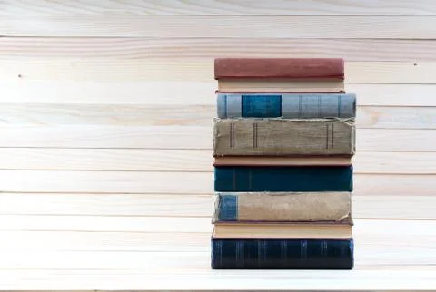 Stack of hardback books on wooden table. Back to school. Stock Photos