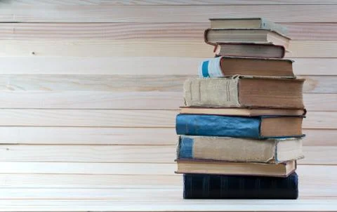 Stack of hardback books on wooden table. Back to school. Stock Photos