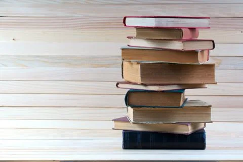 Stack of hardback books on wooden table. Back to school. Stock Photos