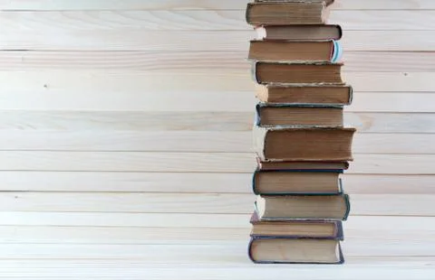 Stack of hardback books on wooden table. Back to school. Stock Photos