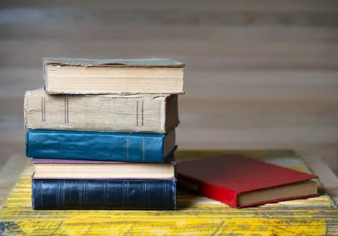Stack of hardback books on wooden table. Back to school. Stock Photos
