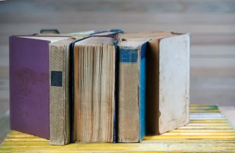 Stack of hardback books on wooden table. Back to school. Stock Photos
