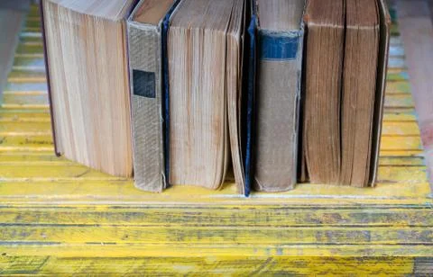 Stack of hardback books on wooden table. Back to school. Stock Photos