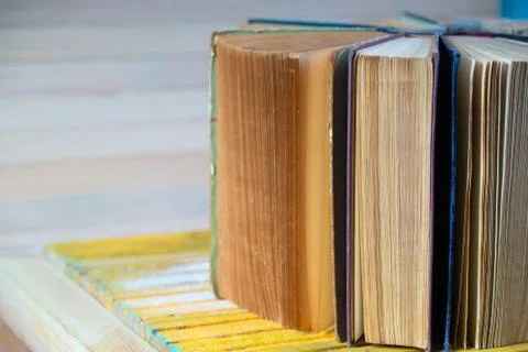Stack of hardback books on wooden table. Back to school. Stock Photos