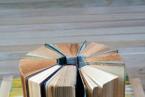 Stack of hardback books on wooden table. Back to school. Stock Photos