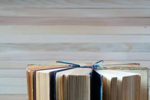 Stack of hardback books on wooden table. Back to school. Stock Photos