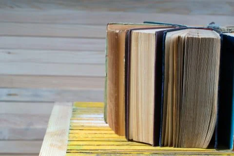 Stack of hardback books on wooden table. Back to school. Stock Photos