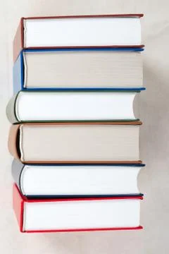 Stack of hardback books on wooden table Stock Photos