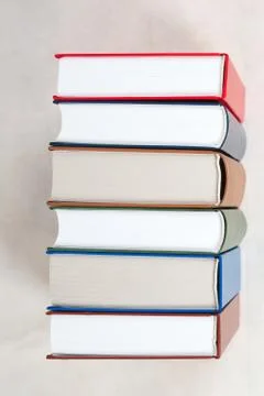 Stack of hardback books on wooden table Stock Photos