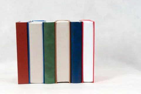 Stack of hardback books on wooden table Stock Photos