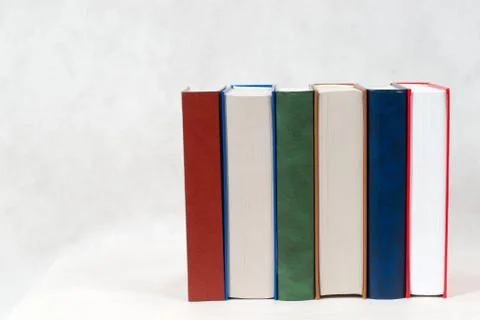Stack of hardback books on wooden table Stock Photos