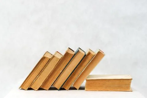 Stack of hardback books on wooden table Stock Photos