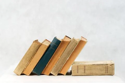 Stack of hardback books on wooden table Stock Photos