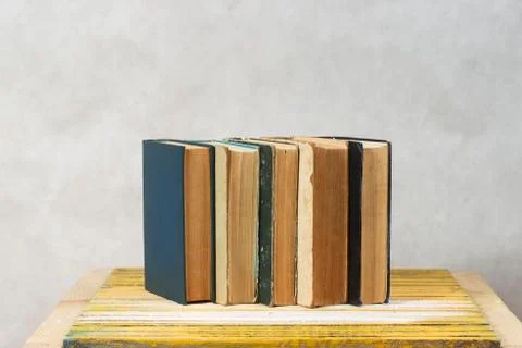 Stack of hardback books on wooden table. Back to school Stock Photos