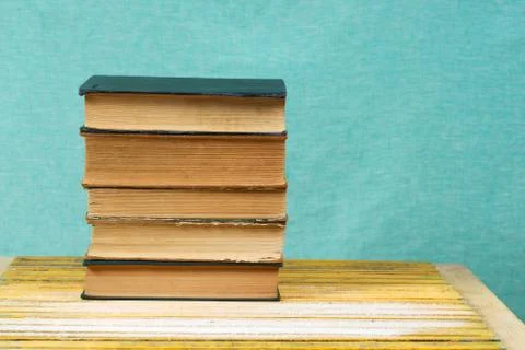 Stack of hardback books on wooden table. Back to school Stock Photos