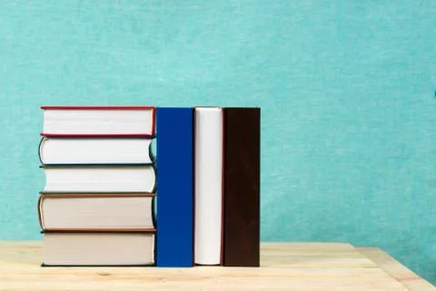 Stack of hardback books on wooden table. Back to school Stock Photos