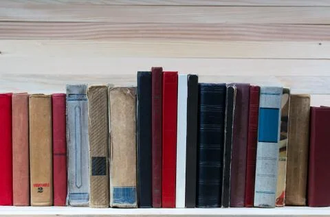 Stack of hardback books on wooden table. Back to school Stock Photos