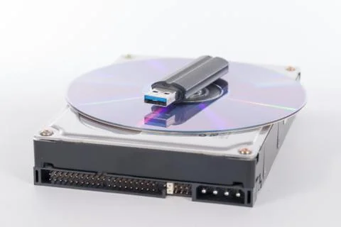 Stack of harddrive, compact disc and USB stick on white backgrou Stock Photos