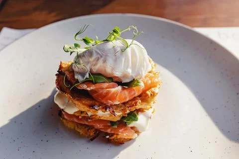 Stack of hash brown with salmon and poached egg on the top. Stock Photos