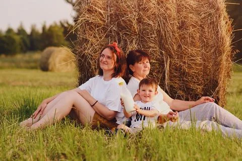 The stack of hay bales creates a beautiful backdrop for a portrait of a woman Stock Photos